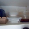 Shelf with plastic containers stored with lids.