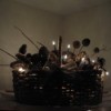 Lighted holiday basket with pinecones and twigs