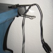 Large paper clip attached to table for cord.