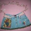 Jeans purse with ribbons and other decorations.