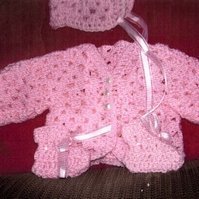 Pink crochet baby sweater.