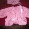 Pink crochet baby sweater.