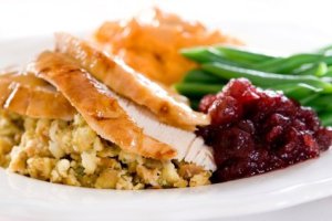 Thanksgiving Leftover Recipes. A Thanksgiving plate of turkey, stuffing, mashed potatoes, gravy, veggies and cranberry sauce.