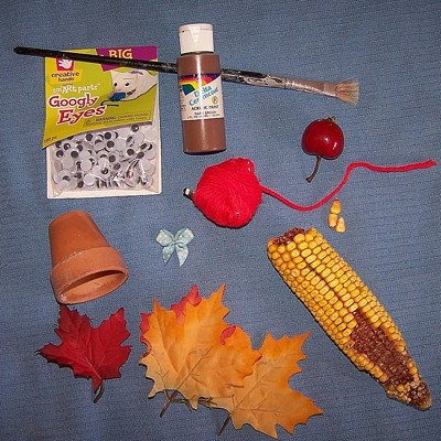 Photo of a clay pot turkey craft.