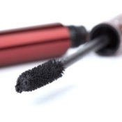 Open tube of mascara with brush prominent.