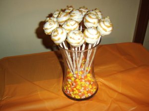 Cake pops in a jar of candy corn.