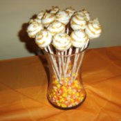Cake pops in a jar of candy corn.