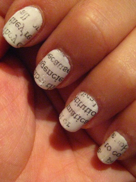 Newspaper print applied to nails.