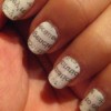 Newspaper print applied to nails.