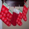 A group of Christmas stockings hanging on a shelf.