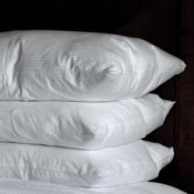 A stack of soft fluffy down pillows.