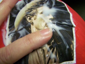 Rub out all the air bubbles and excess glue from the back of the picture.