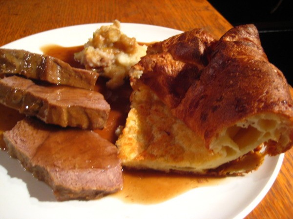A dinner plate of beef and Yorkshire pudding.
