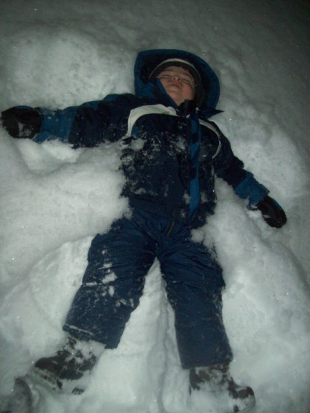 Child making his first snow angel.