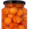Jar of canned papaya balls in syrup.