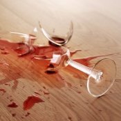 Removing Red Wine Stains from Hardwood Floors, Broken glass of red wine on wood floor.