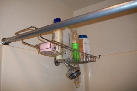 A wire bathtub shelf placed on shower curtain rod.