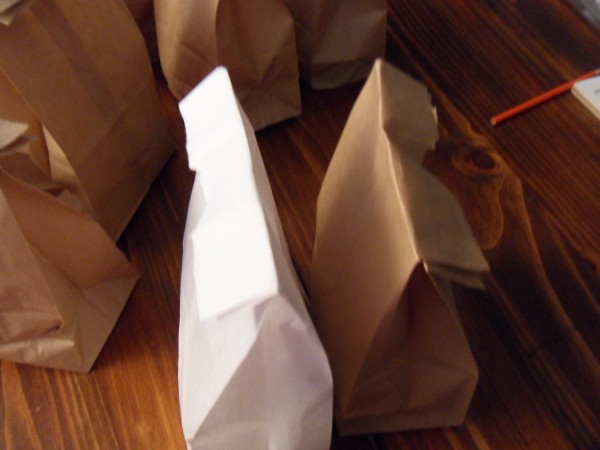 Brown and white lunch bags folded down after adding mix.