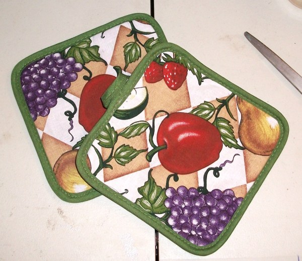 Two pot holders with fruit motif.