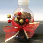 Cookies stacked in 8 oz. water bottle with ribbon and decorations tied around the center.