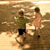Little boy and girl skipping in walking mall