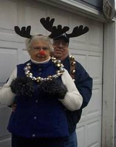 Husband and wife with reindeer antlers and bells