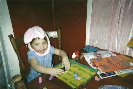 Child in bunny hat coloring.