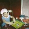Child in bunny hat coloring.