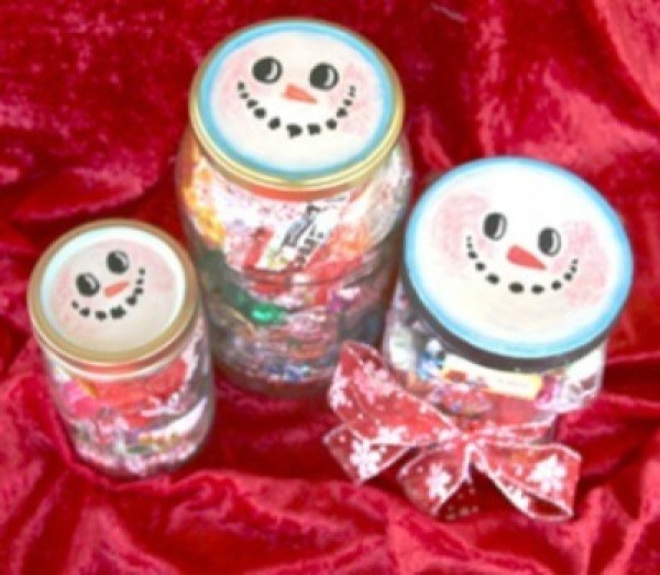 Jar lids decorated to look like snowmen.