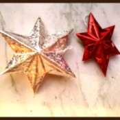 Completed stars, one iridescent silver and one red.