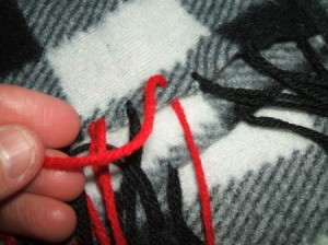 Adjusting yarn fringe.