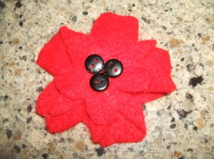 Three buttons added to center of flat flower.