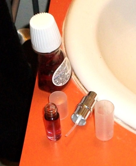 Small open perfume bottle on sink counter.