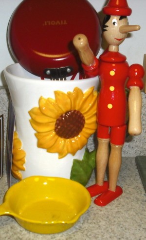 Sunflower canister and wooden Pinocchio doll.