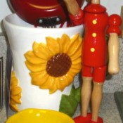 Sunflower canister and wooden Pinocchio doll.