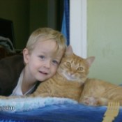 Young boy with Tigger the cat.