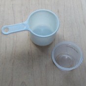 Measuring cup next to empty apple sauce container.