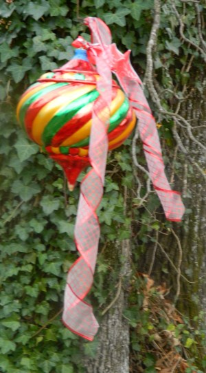 Large brightly colored ornament with decorative ribbon.