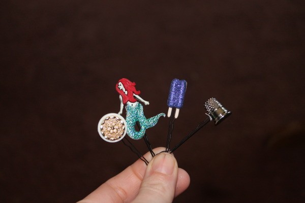 Finished button bobby pin hair accessory.