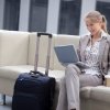 Business Travel Tips, Business Woman on Laptop in Airport