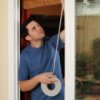 Weatherizing Your Home, Man Weather Stripping His Windows