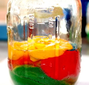 Brightly colored cake mix layered in mason jars.