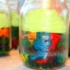 Rainbow cake with frosting, served in the mason jars.