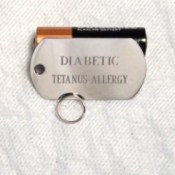 Dog tag used as medical ID with "Diabetic" on the first line and "Tetanus Allergy" on the second.