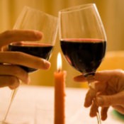 Valentine's Day Dinner Ideas, A romantic candlelit dinner for two with wineglasses.