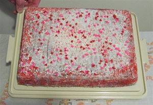 A Valentine's Day cake with pink and red candy confetti.