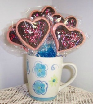 A bouquet of heart shaped cookies in a coffee cup, for Valentine's Day.