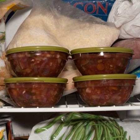 4 glass bowls full of soup in the freezer.