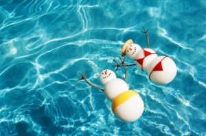 Saving Money on Winter Vacations, Snowman and Snowwoman Enjoying the Pool and Warm Sun Together