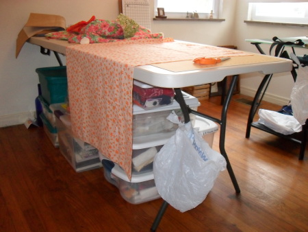A sewing room garbage can by tying a bag to the table leg.